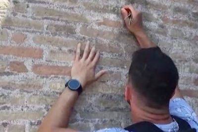 Tourist Caught on Video Carving Fiancée's Name Into Wall of Rome’s Colosseum - travelandleisure.com - Spain - Italy - Usa - city Rome - Saudi Arabia - city Santanche - county Florence