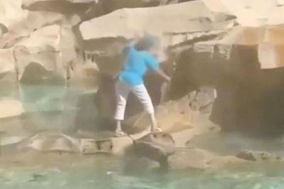Tourist Caught Climbing on Trevi Fountain to Fill Water Bottle — Watch the Video - travelandleisure.com - Italy - Ireland - county Fountain